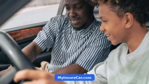 Father teaching teenage son to drive, illustrating how car insurance costs change by driver age