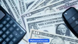 Car key fob and calculator on top of US dollar bills