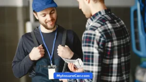 Customer paying a mechanic cash in a garage