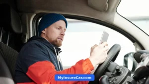 Man using a smartphone while sitting in a parked car