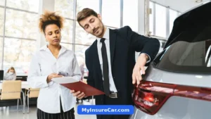 Salesman talking to a customer beside a car in a showroom