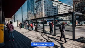 Commuters waiting at a city bus stop with a bus arriving